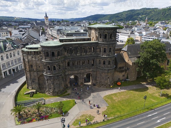 Historical architecture of the Porta Nigra with city panorama, surrounded by mountains and green