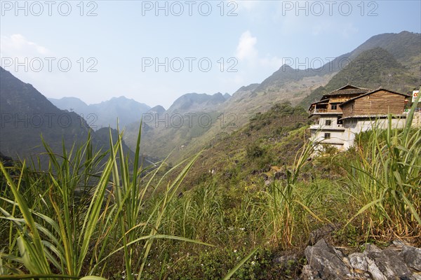 Traditional house and view of northern mountain landscape, Ha Giang province, Vietnam, Asia