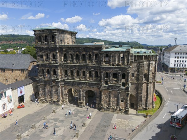 Historical architecture in sunny weather, tourists visiting Porta Nigra in Germany, aerial view,