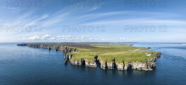 Aerial panorama of the rugged coastal landscape at Duncansby Head with the lighthouse on the right,