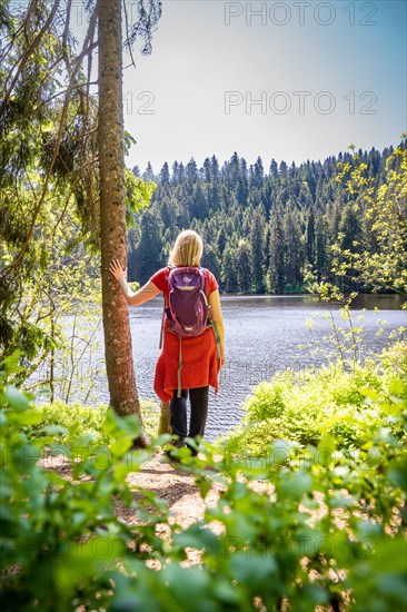 Hiker woman standing by the lake, Glaswaldsee, Bad Ripoldsau, Germany, Europe