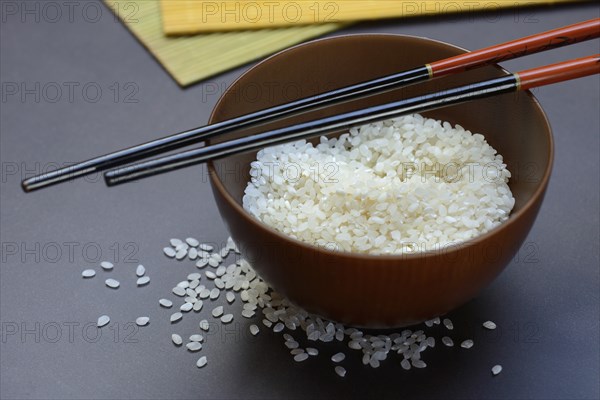 Rice, white rice in bowl with wooden ladle, uncooked