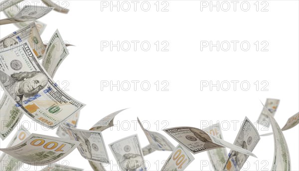 Corner border of falling one hundred dollar bills isolated on a white background