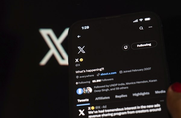 In this photo illustration a person browsing Elon musk X account, formerly Twitter, on an iPhone,