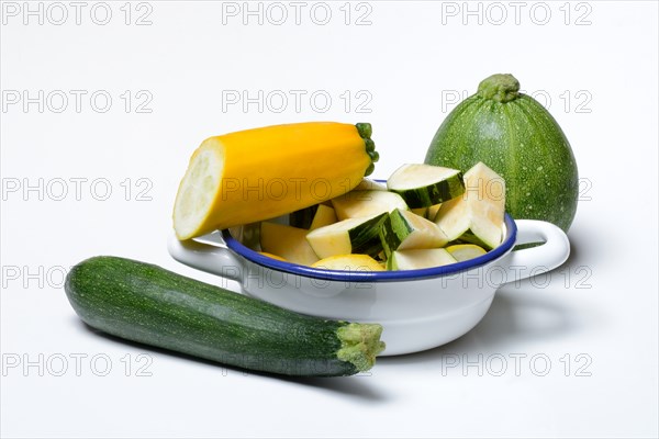 Various courgettes (Cucurbita pepo), courgettes cut up in pot convar. giromontiina