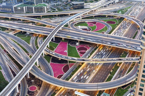 Intersection of Sheikh Zayed Road traffic on the road near the Burj Khalifa with Metro in Dubai,