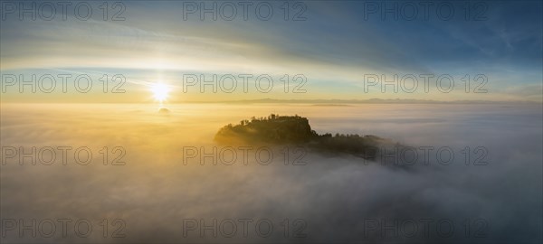 Aerial view of the Hegau volcano Hohentwiel with the upper fortress ruins as a silhouette at