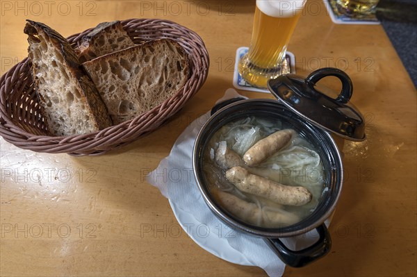 Saure Zipfel, boiled Nuremberg sausages, served with onion in a small pot in a pub, Nuremberg,