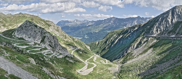 Panoramic view photo with reduced saturation on left Tremola southern historic driveway from Airolo