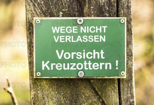 Sign: Do not leave the paths, beware of common european vipers (Vipera berus), warning of poisonous