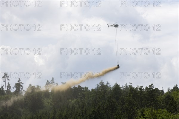Symbolic image, climate change, helicopter, helicopter spreading fine-painted limestone and ash