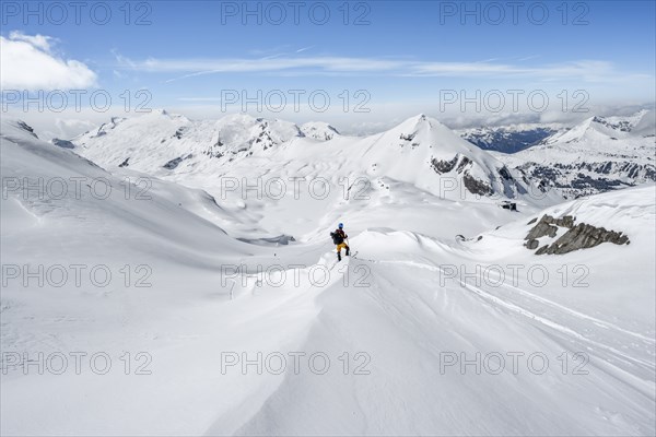 Ski tourers ascending to the Wildstrubel hut, snow-covered mountain landscape with Mittaghorn and