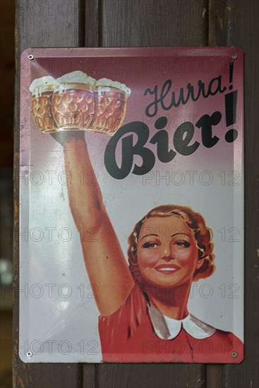 Beer advertising on a metal sign from the 1950s in a beer garden, Bavaria, Germany, Europe