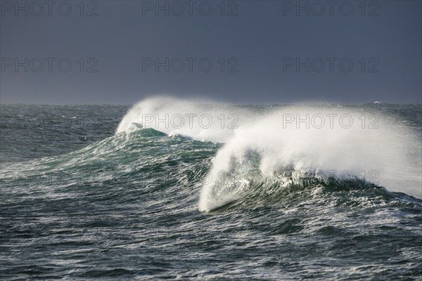 Big wave breaks in the open sea on the Breton coast near Brest, France, Europe