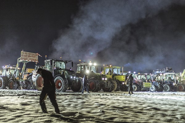 Tractors during a rally as part of the farmers' protests on the snow-covered Kirchbichl,