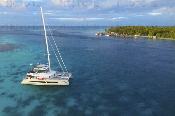 Aerial view, diving ship Aqua-Tiki III, catamaran, aft South Pass, South Channel and Tetamanu