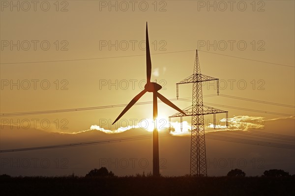 Sunset behind clouds, wind power station, high-voltage pylon, Melbeck, Ilmenau joint municipality,