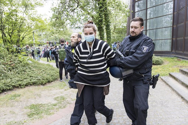 An activist is taken away by the police during the occupation of the courtyard of the Free