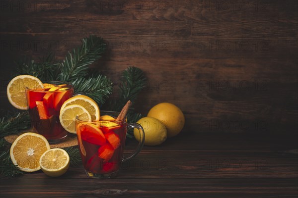 Two glass cups with punch, Christmassy, wooden background, copy room