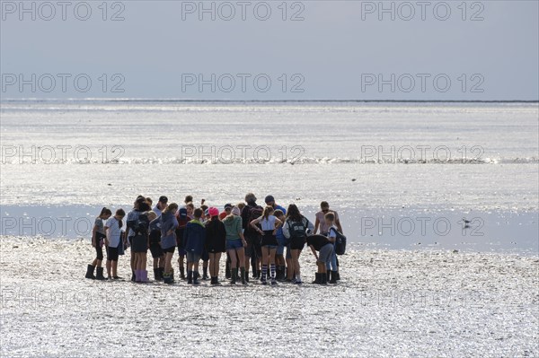 A group of pupils on a mudflat hike in the Wadden Sea National Park, low tide, Norddeich, Norden,