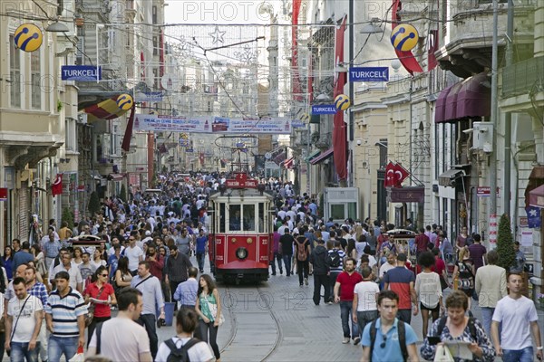 Historic tram in Istiklal Avenue, busy shopping street near Taksim square in the city Istanbul,