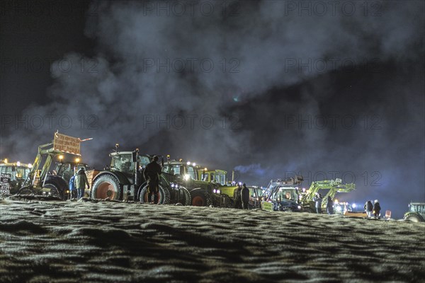 Tractors during a rally as part of the farmers' protests on the snow-covered Kirchbichl,