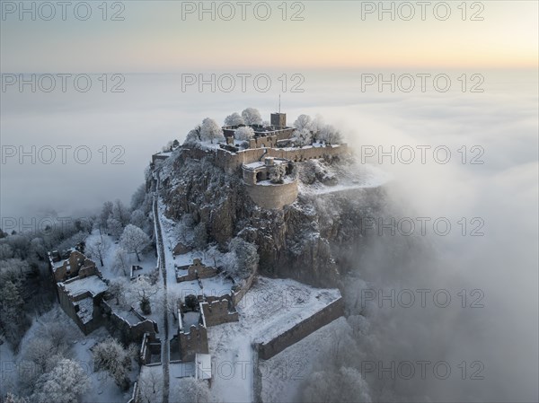 Aerial view of the Hegau volcano Hohentwiel with Germany's largest fortress ruins on a cold, foggy