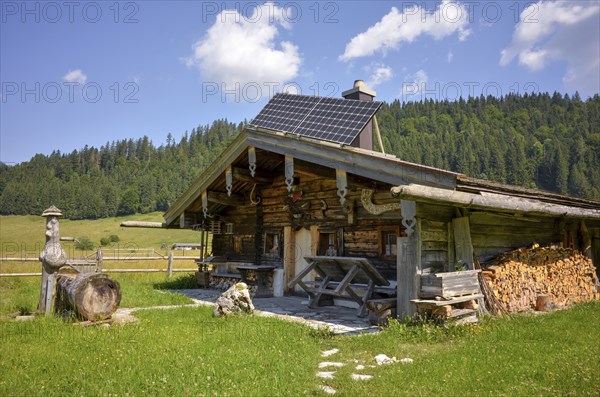 Alpine hut with well and solar panels on the Rötelmoosalm, Chiemgau, Bavaria, Germany, Europe