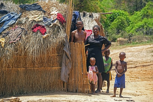 Malagasy family with children posing at their hut at Begidro near Ankiliroroka, Belo sur