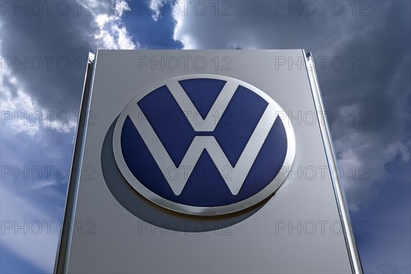 Logo of the car company Volkswagen, cloudy sky, Bavaria, Germany, Europe