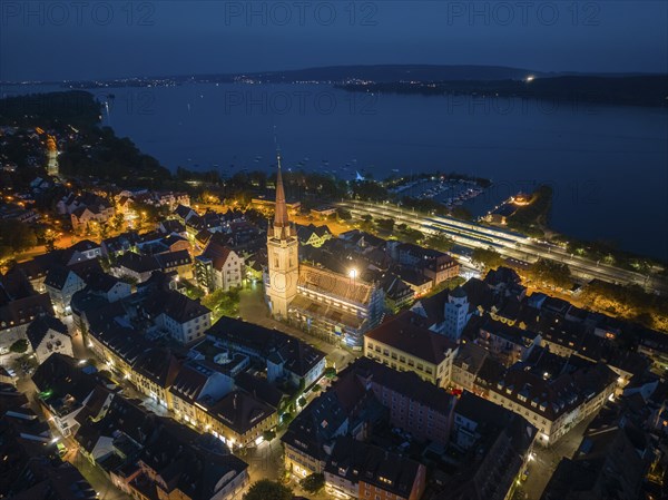Aerial view of the city of Radolfzell at night with the illuminated Radolfzell Minster, Radolfzell