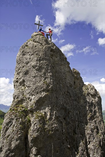 Man climbs to the summit cross on the Losenstein, Austria, Europe