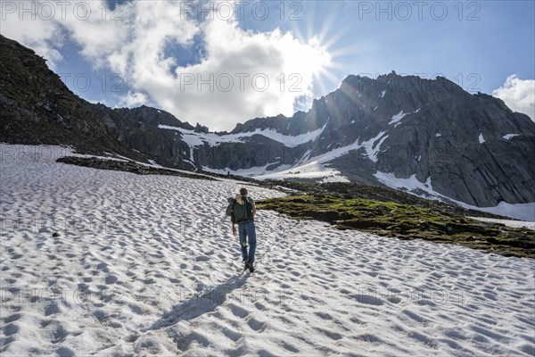 Mountaineer on a snowfield, rocky mountain peak Furtschaglspitze in the background, Berliner