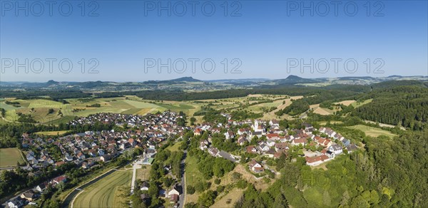Aerial panorama of the town of Aach im Hegau, with the Hegauberge mountains on the horizon,
