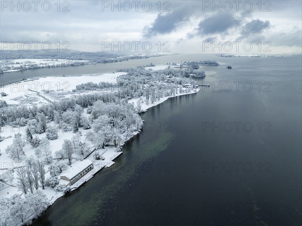 Aerial view of the snow-covered Mettnau peninsula with the Mettnaupark, on the horizon the island
