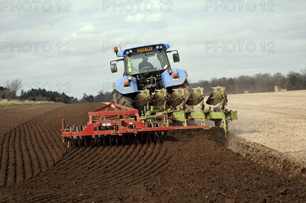 New Holland tractor disc harrowing field, Sutton, Suffolk, England, United Kingdom, Europe