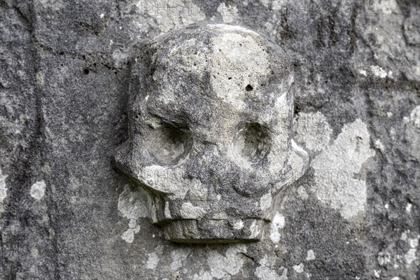 Chiselled skull as decoration on an old weathered gravestone, Kilmartin, Argyll and Bute, Scotland,