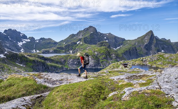 Mountaineer, mountain landscape with rocky pointed peaks and lakes, with mountain