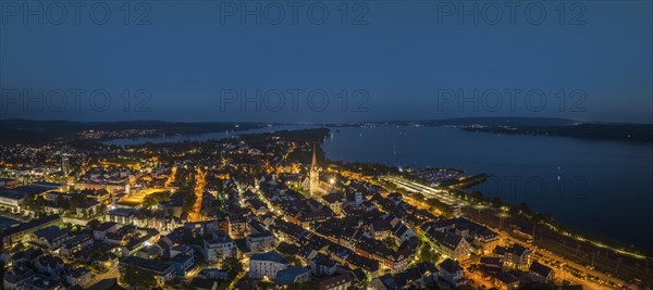 Aerial panorama of the town of Radolfzell at night with the illuminated Radolfzell Minster,