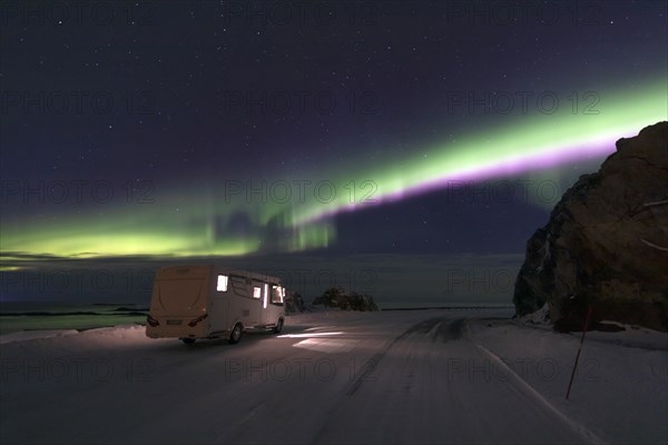 Motorhome and Northern Lights (Aurora borealis) in winter, Andoya, Vesteralen, Norway, Europe
