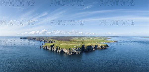 Aerial panorama of the rugged coastal landscape at Duncansby Head with the lighthouse, Duncansby