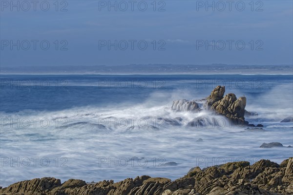 The waves of the Atlantic wash over the rocks on the coast off Penmarch in Brittany. Finistere,