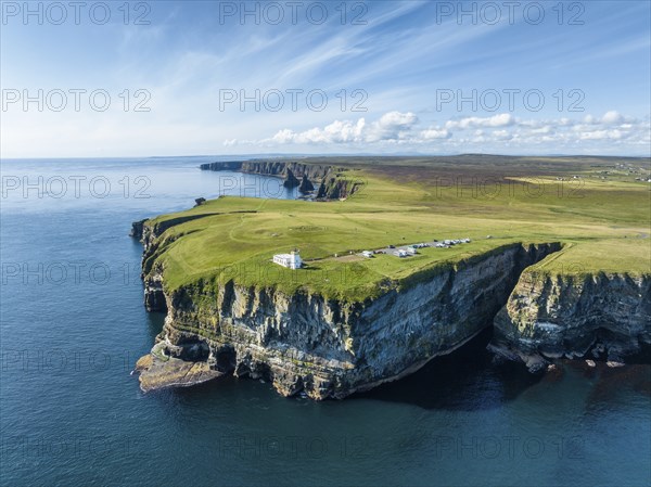 Aerial view of the rugged coastal landscape at Duncansby Head with the lighthouse and the Duncansby