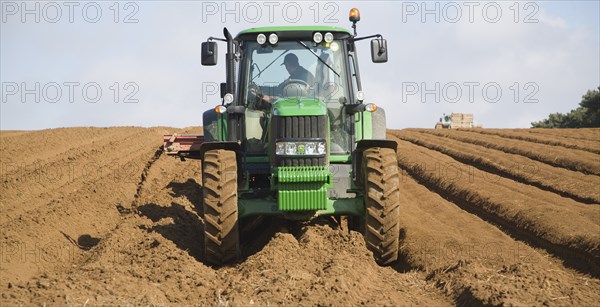 Farm machinery preparing and planting a crop of potatoes in a field, Shottisham, Suffolk, England,