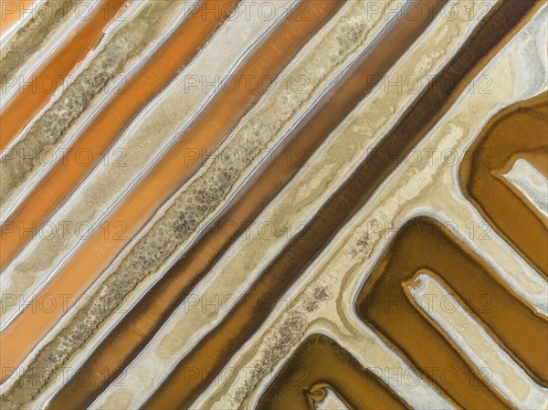 Saline ponds at the salt works near Chiclana de la Frontera. The orange-red colour depends on the