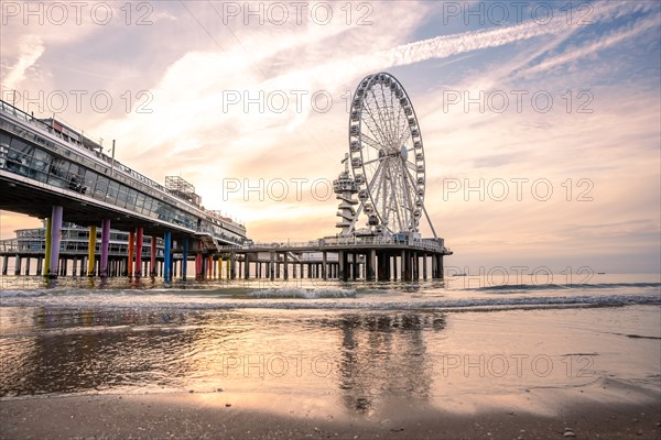 Ferris wheel on the pier on the beach at sunset, The Hague, Netherlands