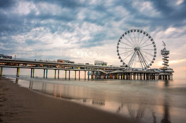 Ferris wheel at sunset on the pier at the beach, The Hague, Netherlands