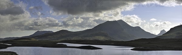 Highland scenery with loch and rain clouds at Assynt, Sutherland, Scotland, UK