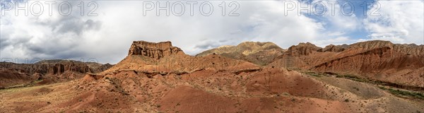 Eroded mountain landscape with sandstone cliffs, red and orange rock formations, Konorchek Canyon,