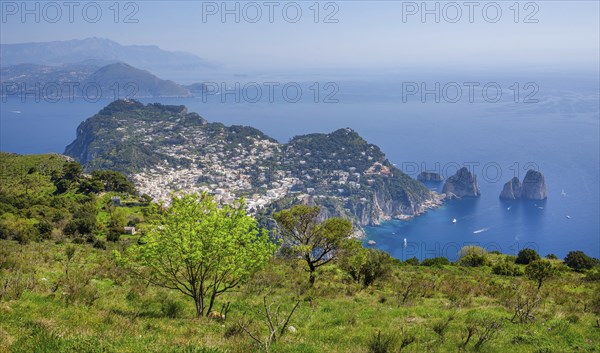 View from Monte Solaro 589m to the south coast with the Faraglioni rocks, the island's landmarks,
